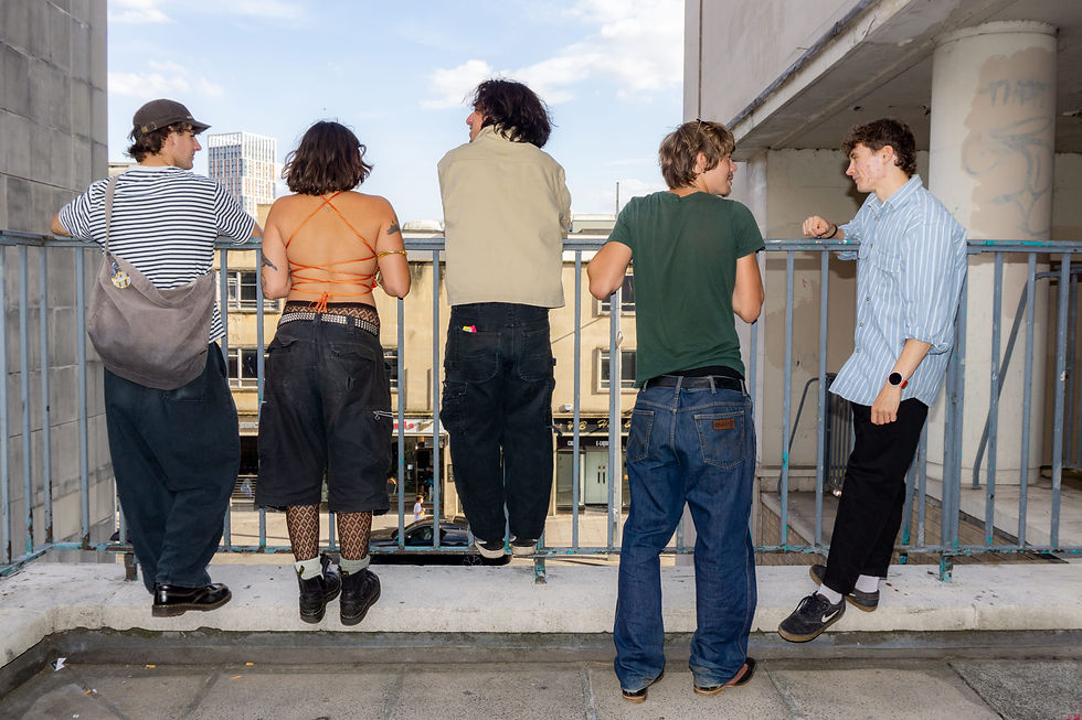 Humdrum the band standing against a rail