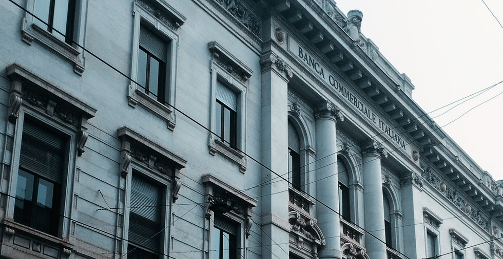 Historic building with classical architecture and tall columns, featuring "Banca Commerciale Italiana" signage. A sense of grandeur and elegance is conveyed.