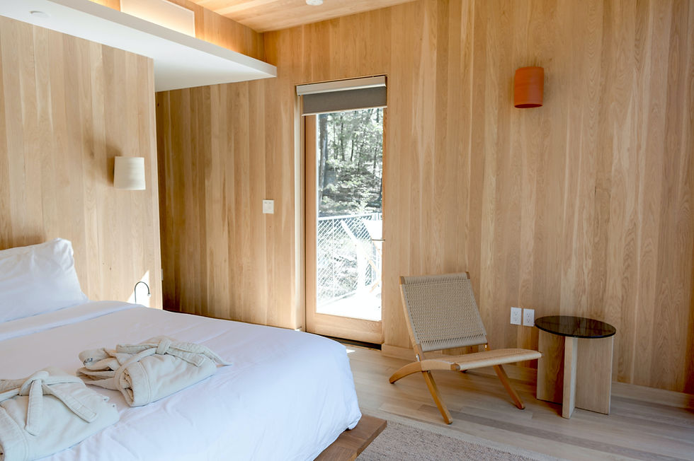 a white bedroom with wood accents and a wood grain wall