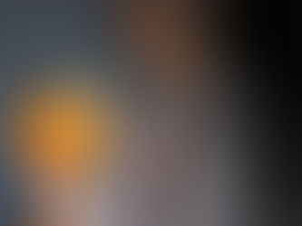 A woman holding a warm glass of orange Happy Juice, representing the moment women with winter blues find something that finally helps them feel like themselves again.