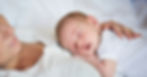 A mother resting with her newborn baby sleeping on her chest representing the postpartum recovery and the physical and emotional demands of early motherhood from the Stress Less Era.