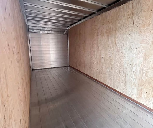 Interior of enclosed trailer with aluminum floor and plywood walls