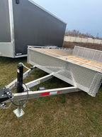 2027 80 in x 12 ft aluminum utility trailer with tandem 3,500 lb drop axles, hardwood decking, 6 D-ring tie-downs, 15 in mag wheels and LED lights. Fully welded box, solid dowel top rail and 7K sidewind jack. Includes a 3-year warranty. Scratch-and-dent sale — save $500. Now $5,350.