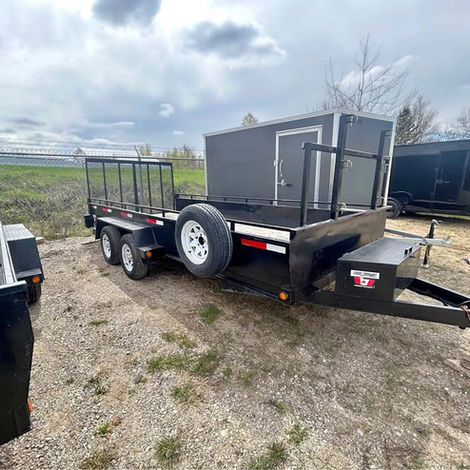 Used 2018 7x16 landscape trailer with tandem 3500 lb axles, split gate, toolbox, ladder racks, and heavy-duty tie-downs. Ideal for landscaping crews and equipment hauling.
