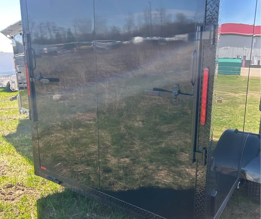 Rear ramp door on blackout cargo trailer