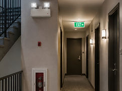 Emergency lighting in a multi-unit building corridor