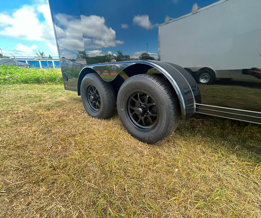 Close-up of the tandem 3,500 lb axles and black wheels on a 2027 Canadian Made Blackout
