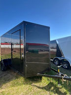 6.5x12 blackout enclosed trailer with ramp door, side door, 7’ interior height, tubular frame construction, and black wheels. Ideal for cargo, motorcycles, contractors, and recreational hauling.