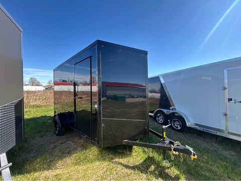 6.5x12 blackout enclosed trailer with ramp door, side door, 7’ interior height, tubular frame construction, and black wheels. Ideal for cargo, motorcycles, contractors, and recreational hauling.