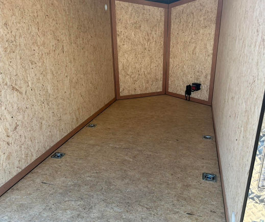 6x10 V-nose enclosed trailer rear ramp door open showing cargo area.jpg
