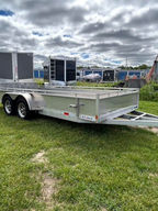 Like-new 2025 ENBEK 7x16 aluminum utility trailer featuring a fully aluminum frame, triple tongue construction, bifold gate, mag wheels, hardwood decking, LED lighting, and eight D-rings for secure cargo transport.