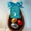 Miniatura: Medio huevo de Pascua 13 cm relleno de dulce de leche con 6 mini huevitos, presentado en envoltorio transparente con lazo tur