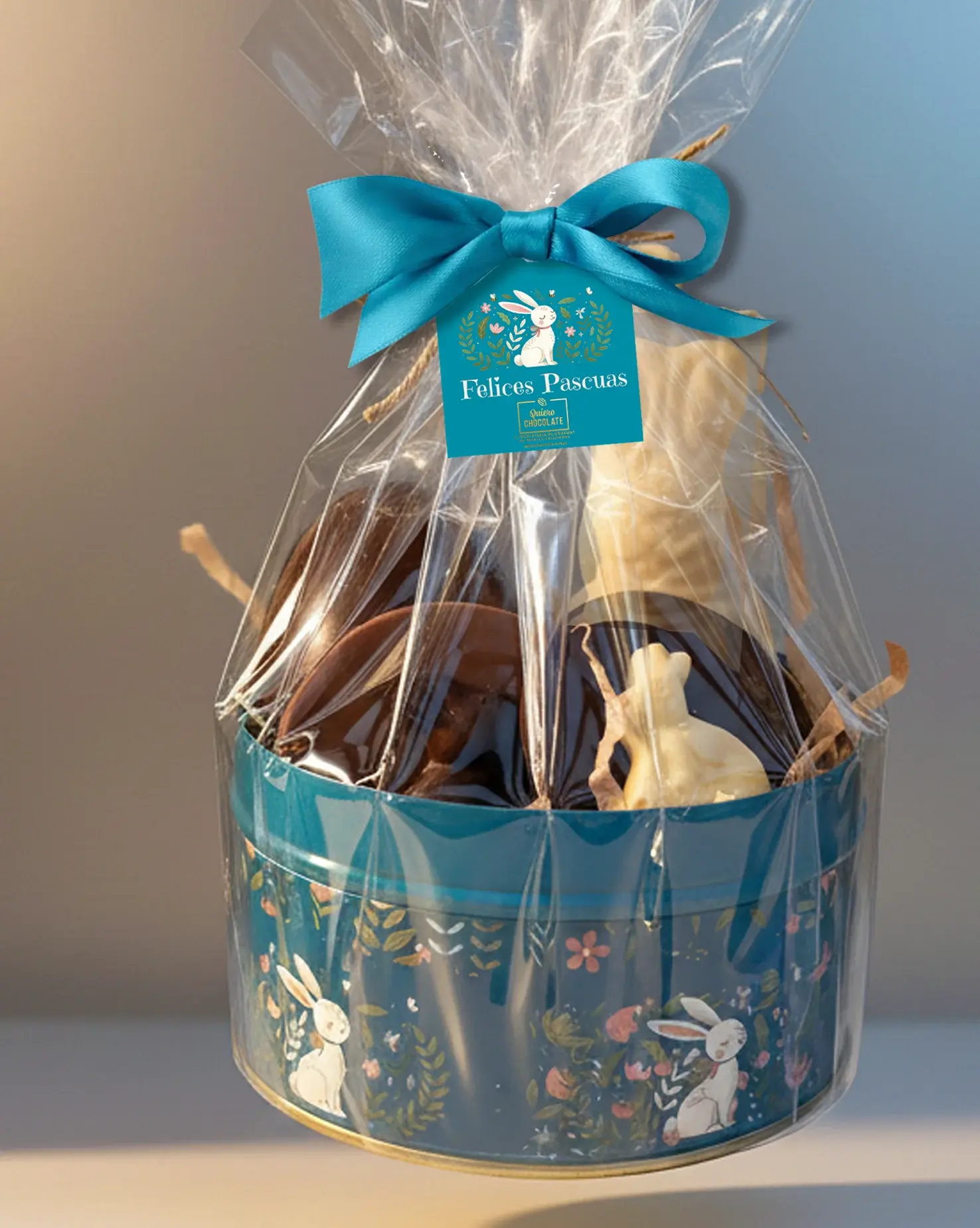 Lata de Pascua ilustrada con conejo de chocolate belga 75 g, huevos y figuras de chocolate, presentada en envoltorio transpar
