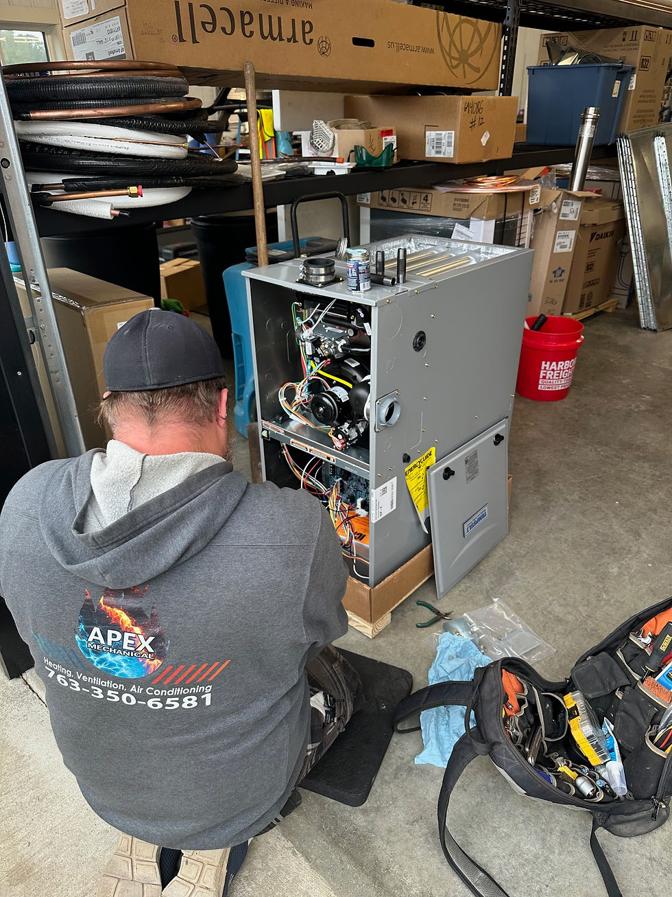 Apex Mechanical technician servicing a residential furnace