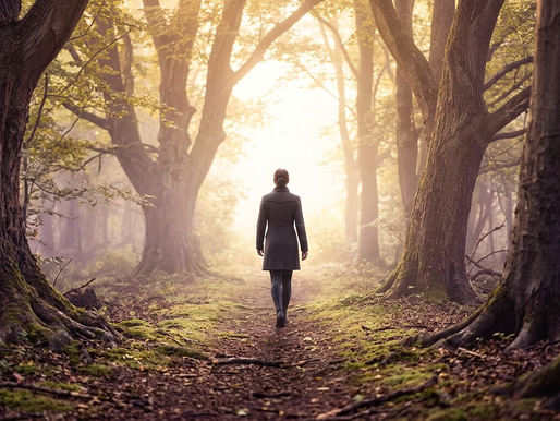 Woman walking through a peaceful forest toward sunlight, symbolizing a journey of healing, self-discovery, and personal growth.