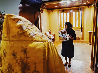 Baby receiving baptism and consecration photo inside church