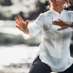 Woman practicing Tai Chi Quan in the par