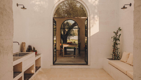 Minimalist interior with arched doorway and natural stone surfaces
