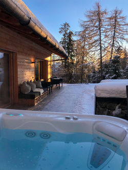 Outdoor whirlpool terrace at K-Lodge in Olang near Kronplatz