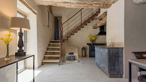 Entrance hall with staircase inside a stone villa in Umbria