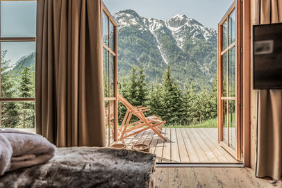 Open balcony with panoramic mountain view in wooden alpine chalet