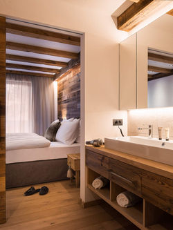 Modern wooden bathroom with double vanity and stone details