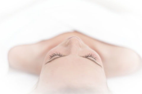 Client relaxing during facial at spa Southern Pines NC