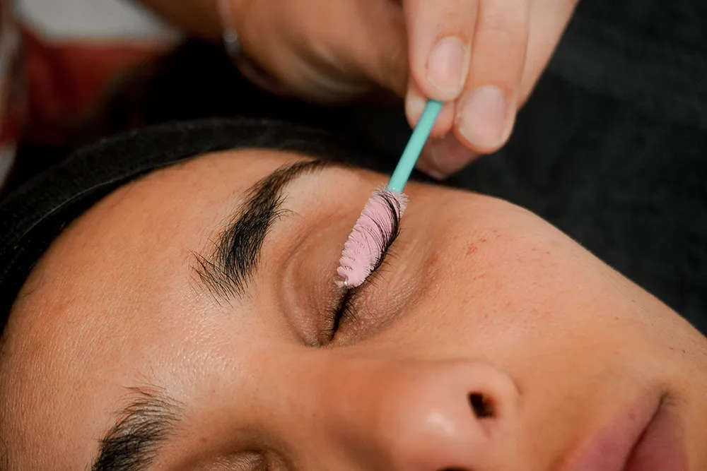 Lash lift product being applied with a brush wand at Revive Spa in Southern Pines to boost curl and lash longevity
