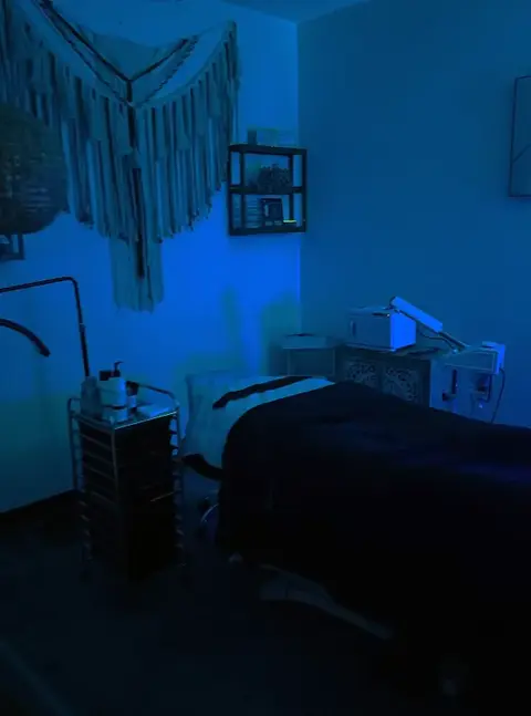 Dark treatment room glowing with LED lights at Revive Spa in Southern Pines, perfect for relaxing facials
