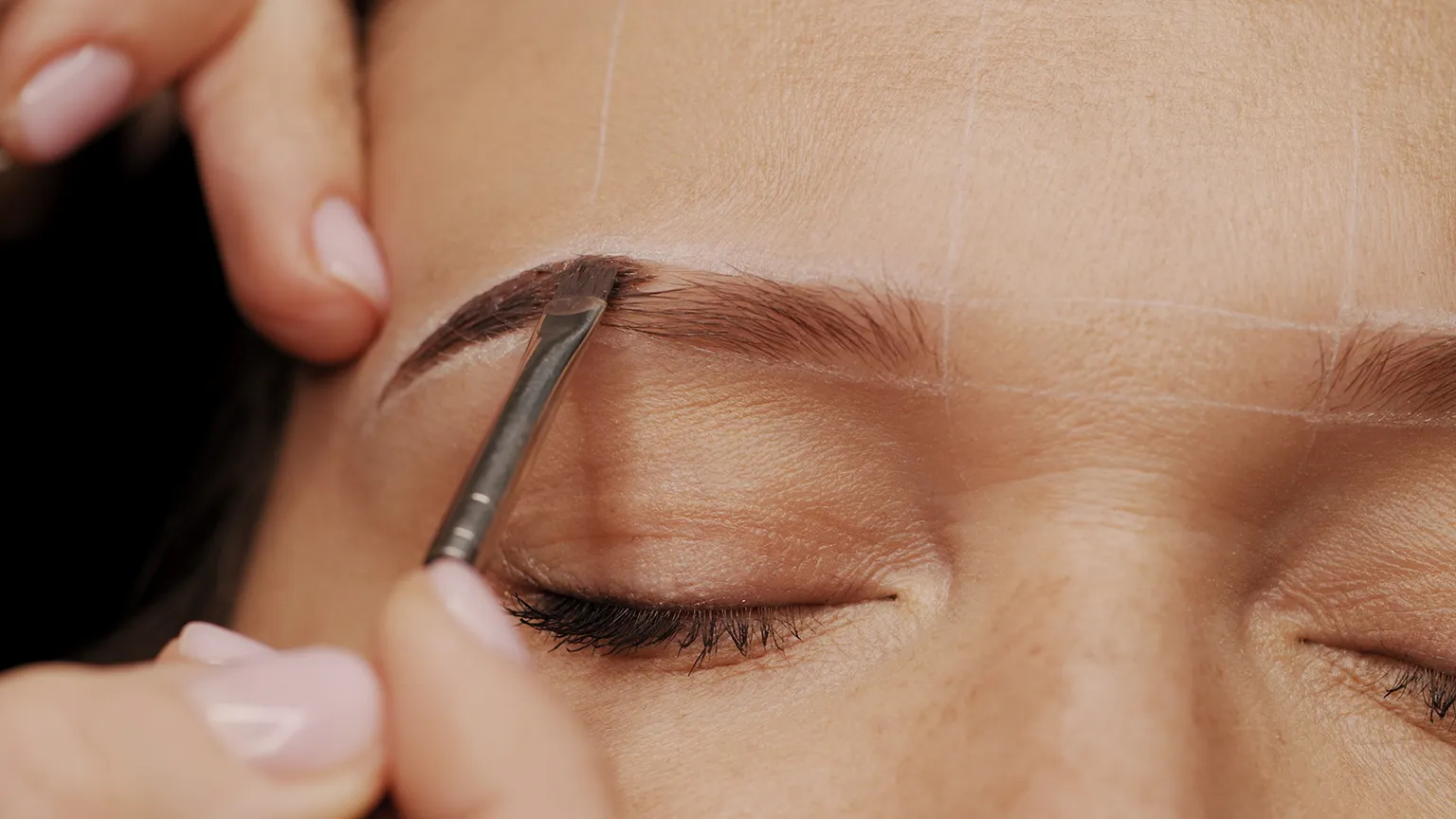 Precision eyebrow shaping using a brow brush at Revive Spa in Southern Pines, enhancing natural brow definition with expert care