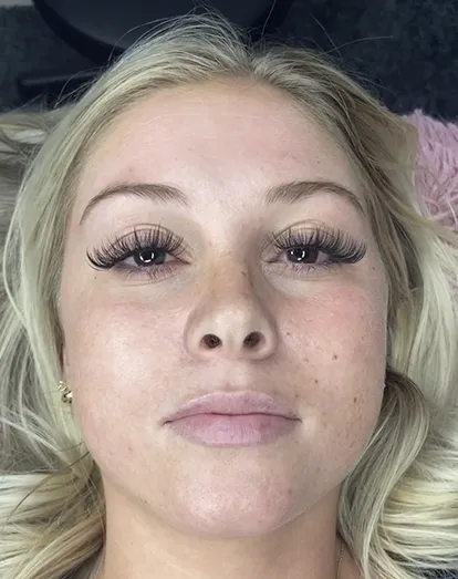 Client showing off full volume lash extensions from Revive Spa & Lash Lounge, a Southern Pines spa known for eye-enhancing beauty treatments.