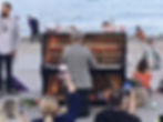 Four men carried a piano to the beach