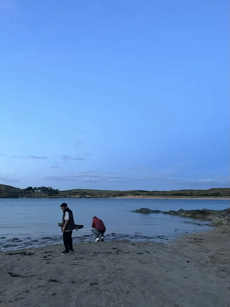 man with skateboard on sand on beach