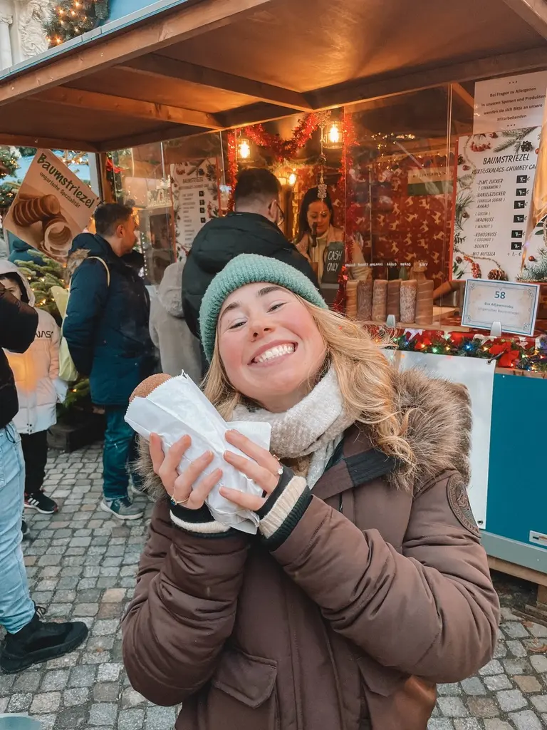 Girl smiling with sweet treat at Berlin Christmas Market