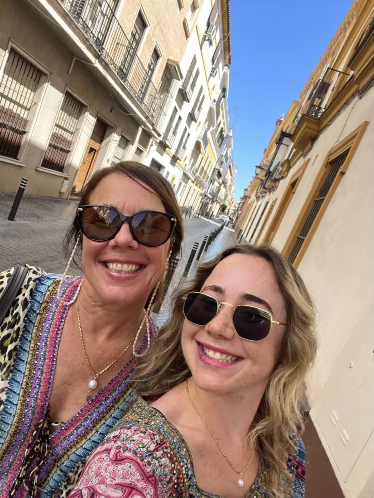 Mother and daughter smiling in streets of Seville