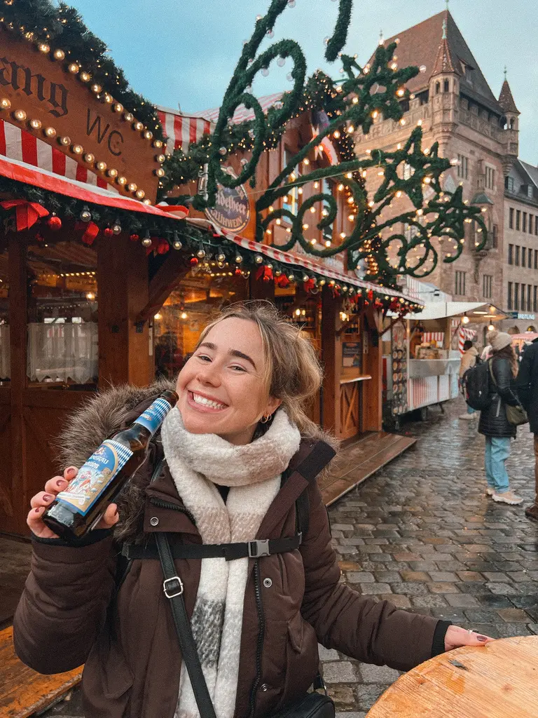 Girl smiling with beer at nuremberg christmas market