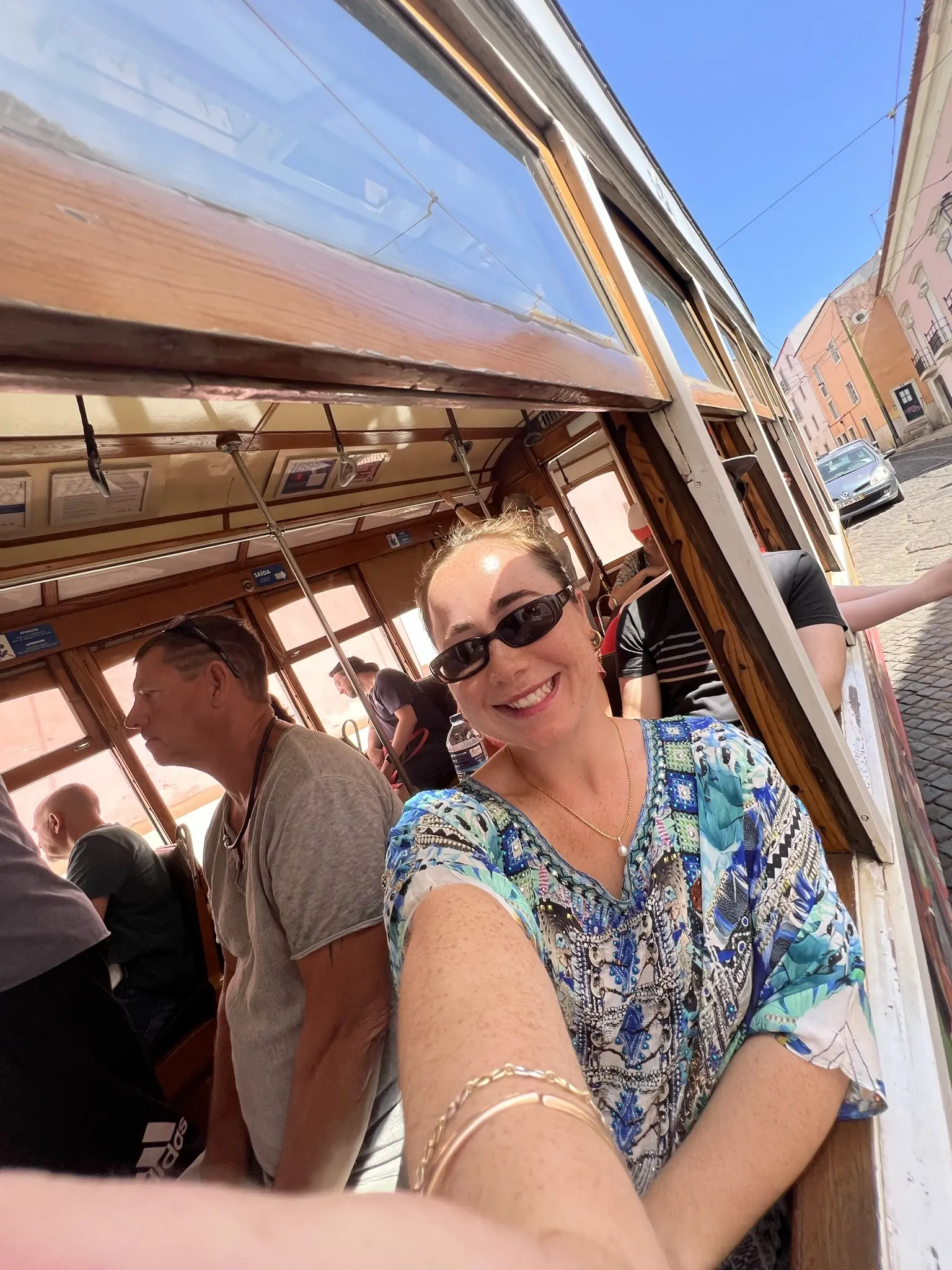 girl smiling and riding the trains in lisbon