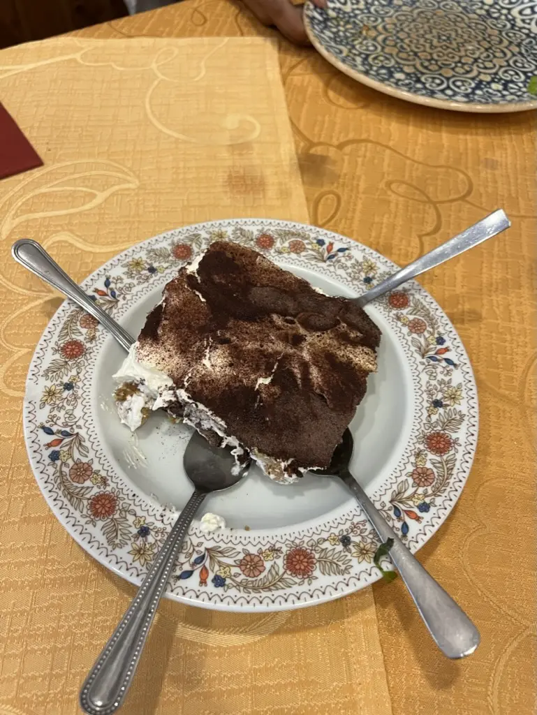 tiramisu and spoons on a plate in rome