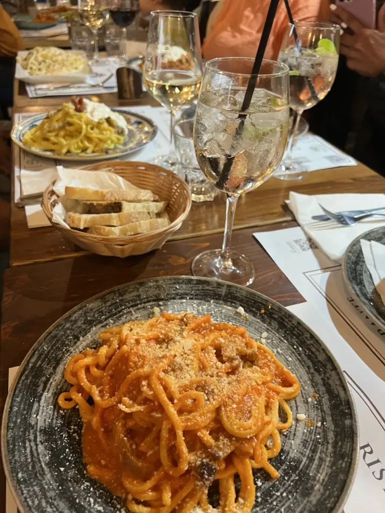 Plate of pasta and wine in rome