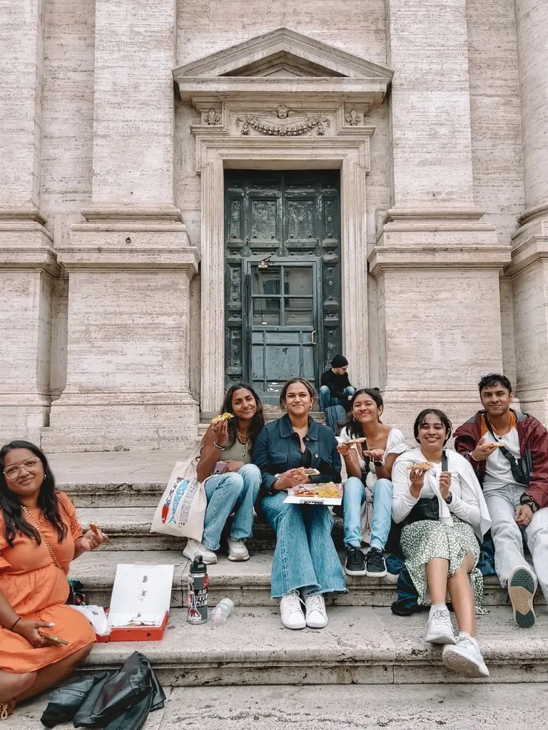 Friends eating pizza on italy steps