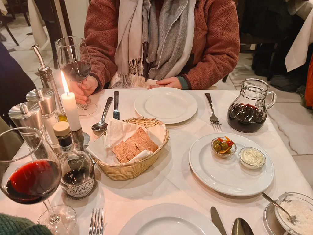 wine and bread on table with candle