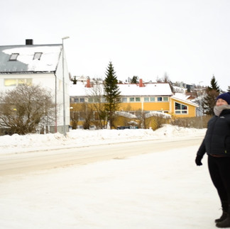 girl standing in street with snow heaped in tromso