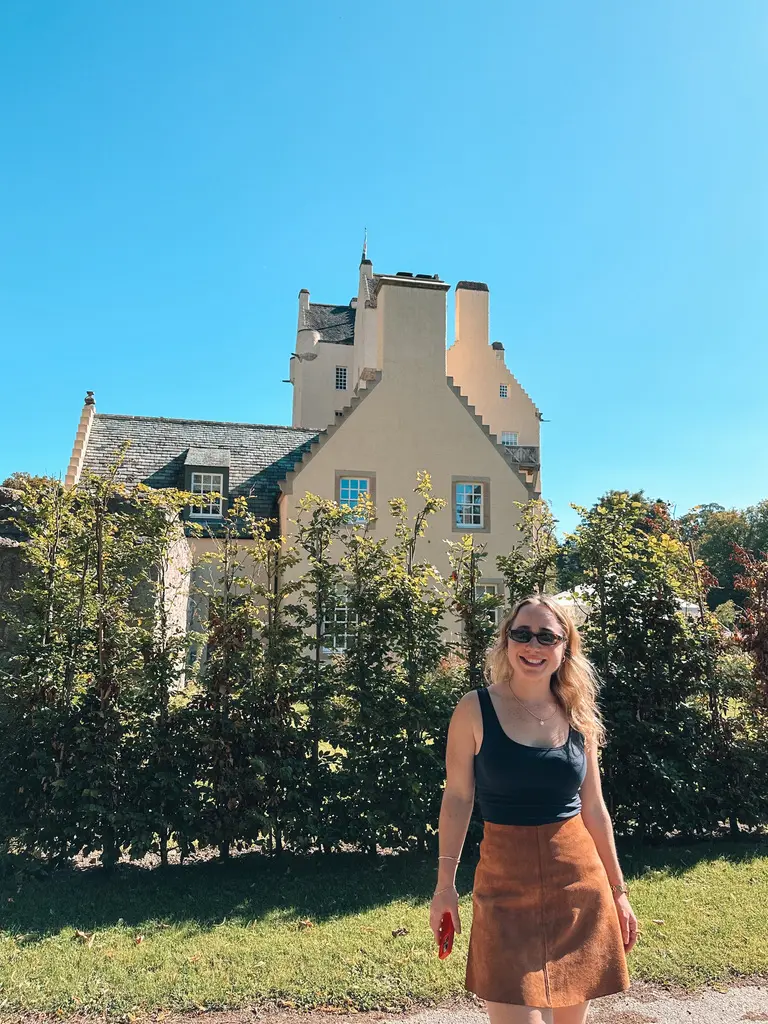 girl smiling in front of castle in ballater scotland