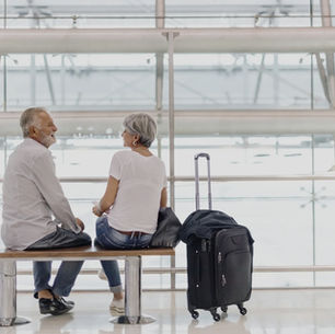 Senior couple sitting calmly in an airport waiting area before their flight