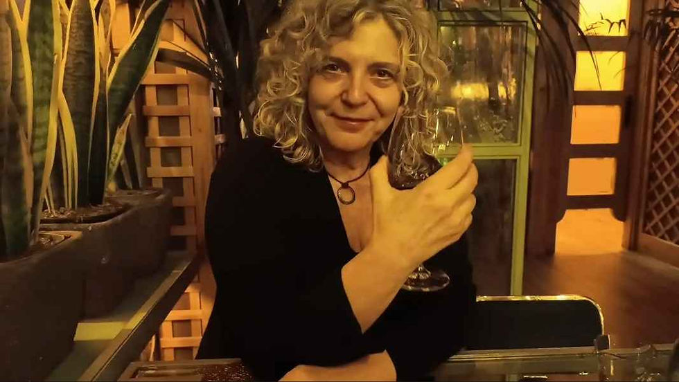 Woman enjoying a coffee break inside a classic Madrid café, relaxed and smiling.