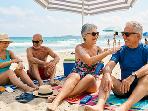 Older adults enjoying the beach while protecting their skin from the sun