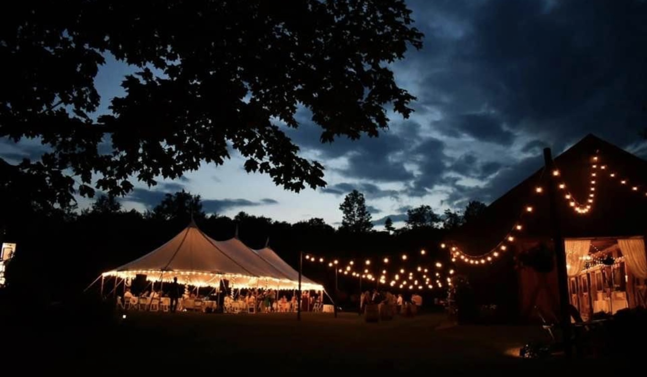 Evening reception view showing the barn and sailcloth tent