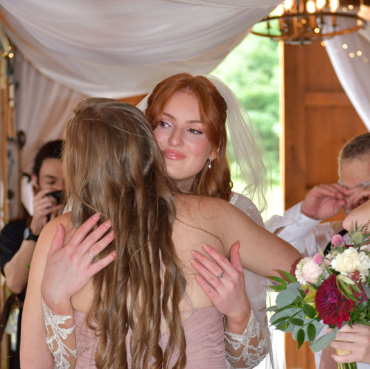 Bride and Bridesmaid hugging