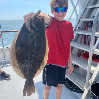 Family Friendly Fluke Fishing on the Island Princess Captree! Kid in red shirt holding a giant fluke