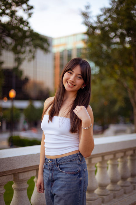 High School Senior modeling for the camera by an open field at the state capital in Madison, WI